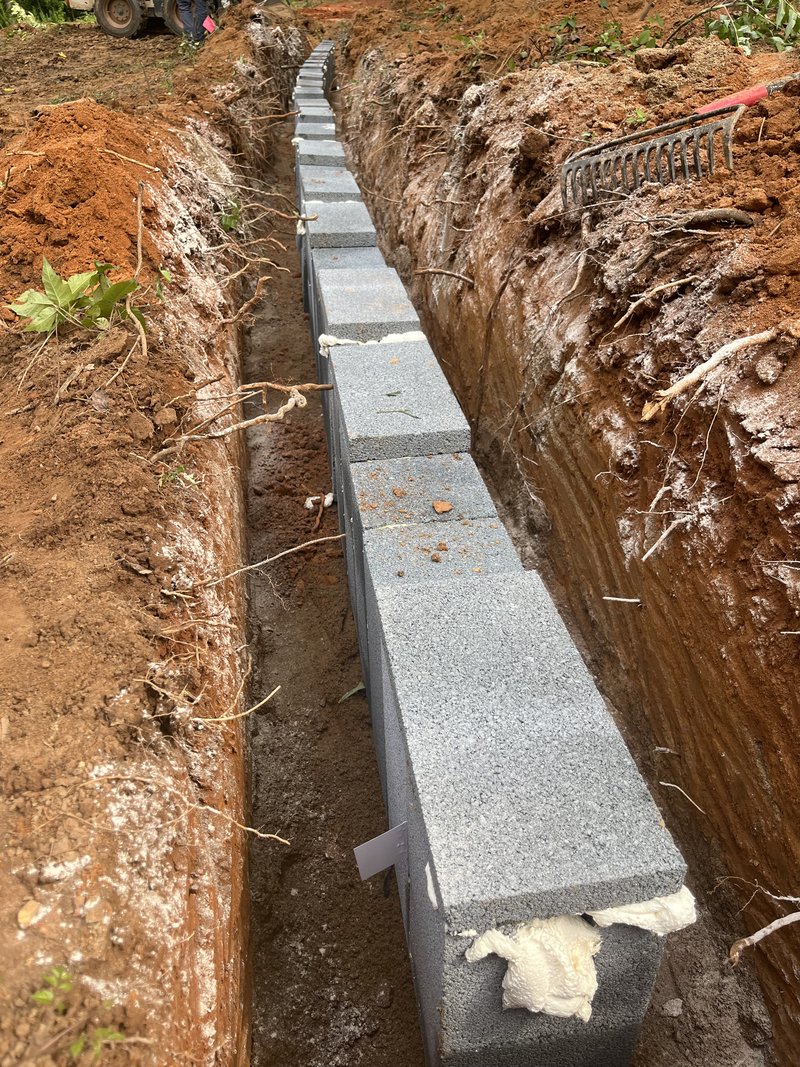 Cinder block distribution line trench for a septic drain field on a Troutman, NC property